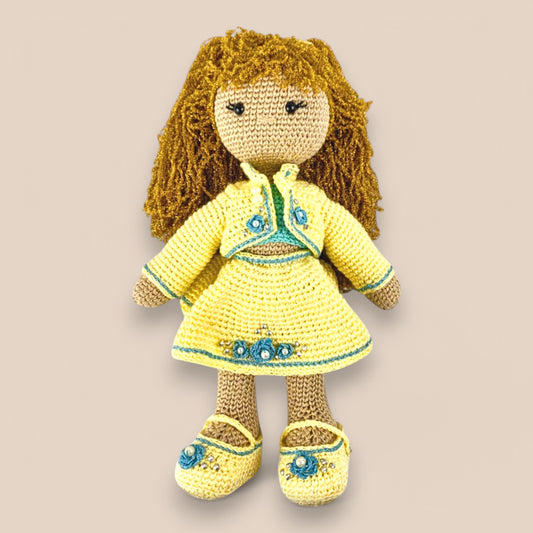 a 14 inch handmade crochet doll wearing yellow handmade clotes with blue crochet flowers and golden hair made of purse thread