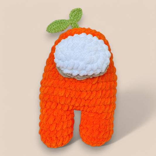 Orange handcrafted crochet toy with white face and greenleaf on top front view