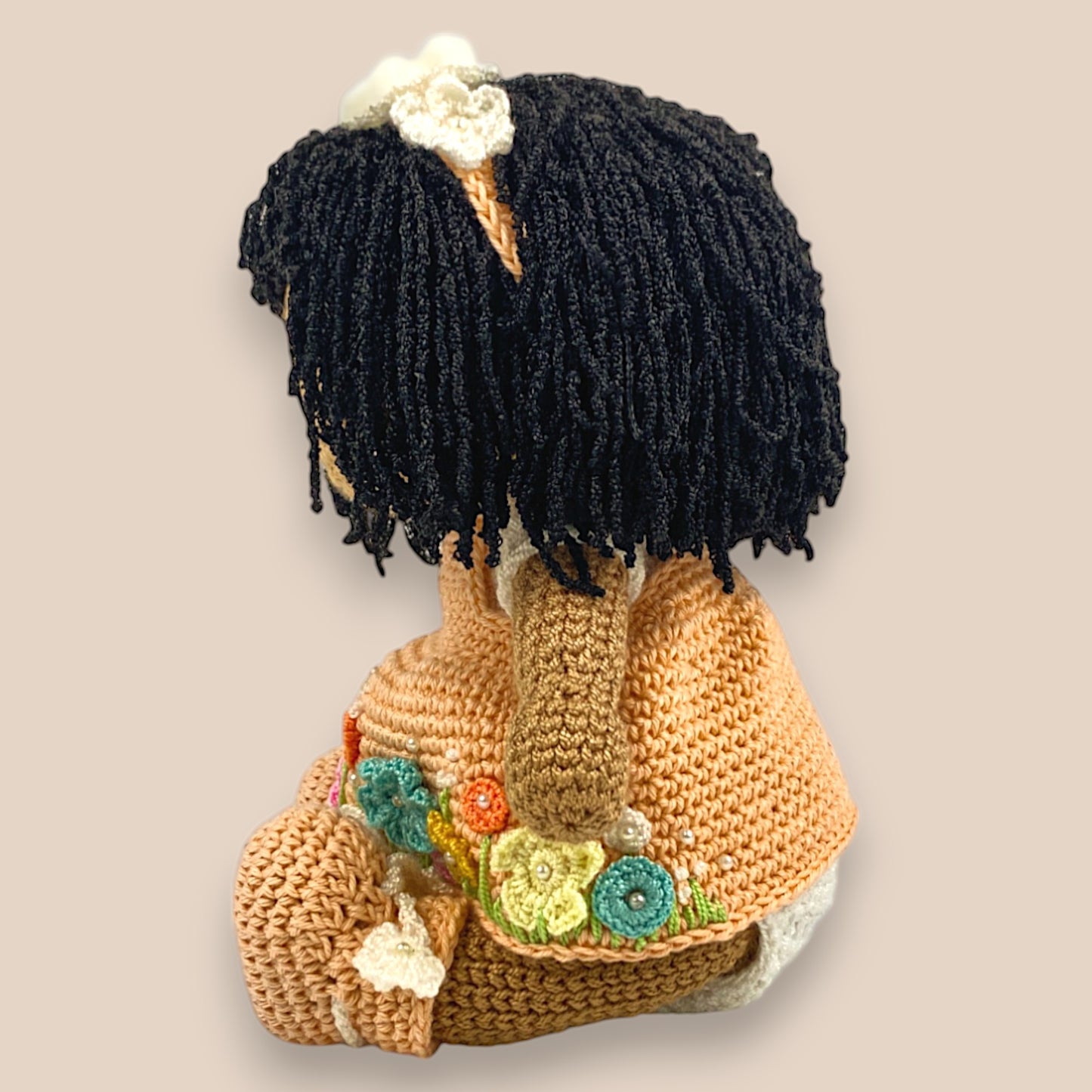side view of chinni displaying her dress with intricate crochet flowers