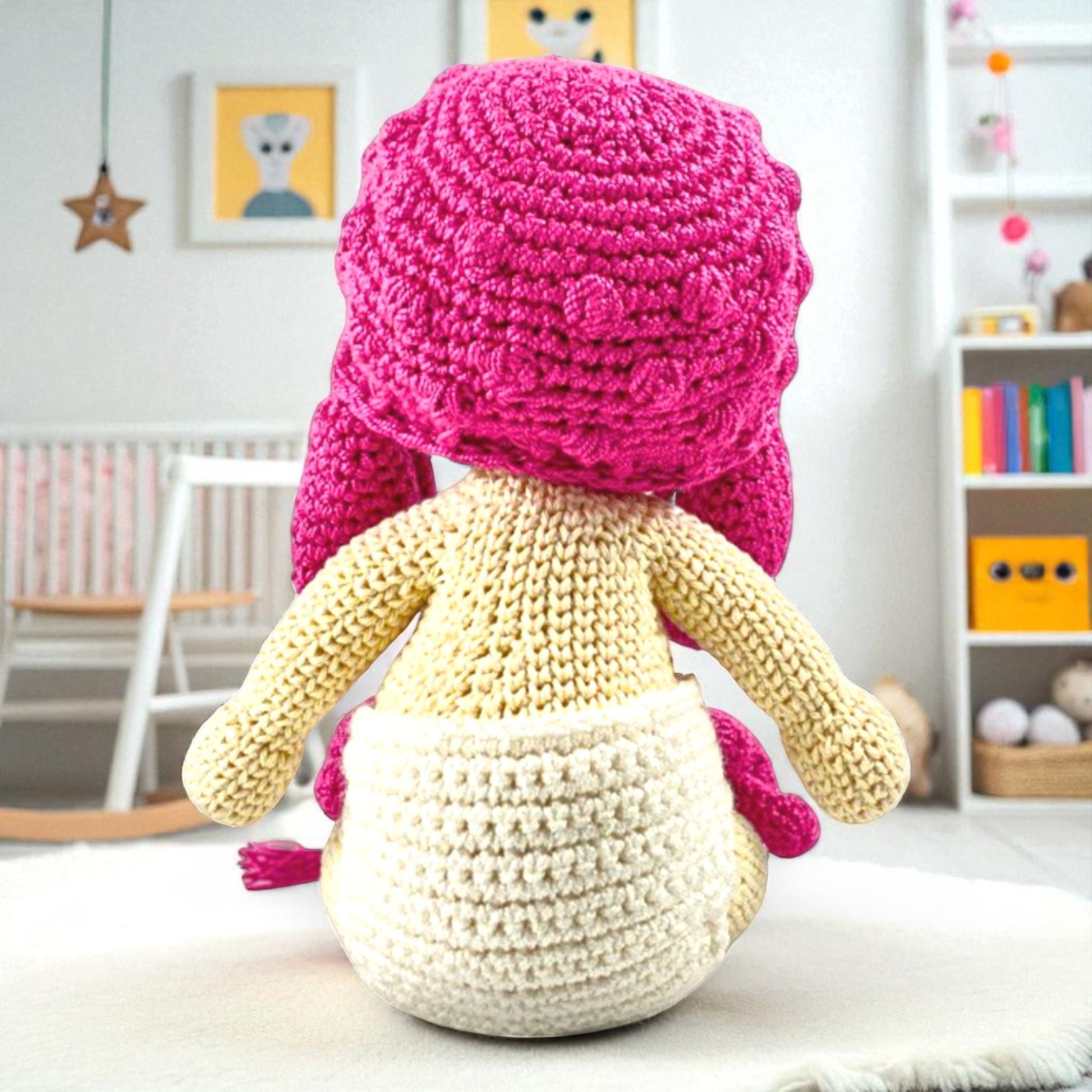 back view of handmade doll with pink cap