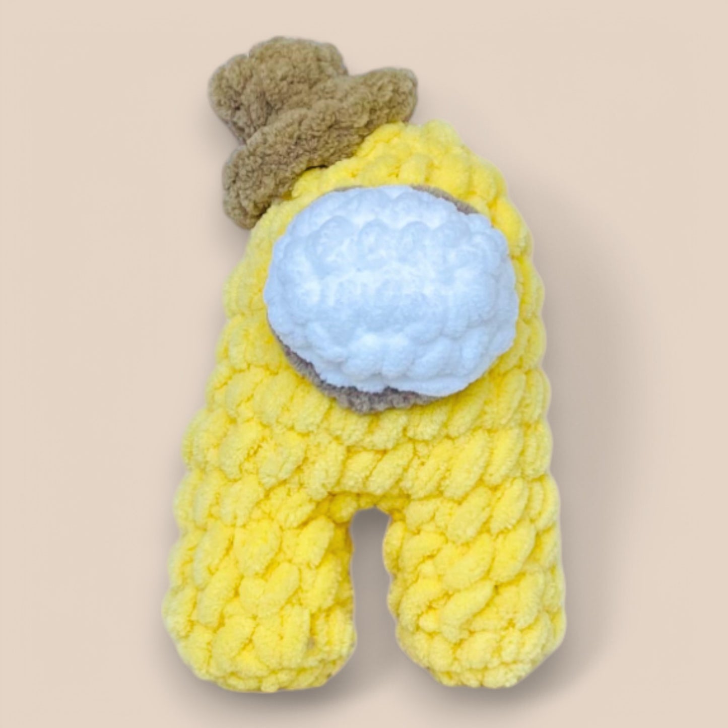 close of yellow handmade crochet Amongus plushy