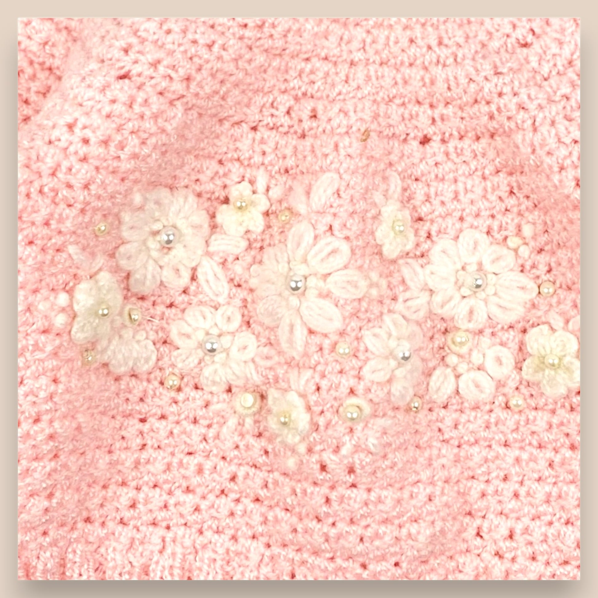close up of crochet flowers in sweater