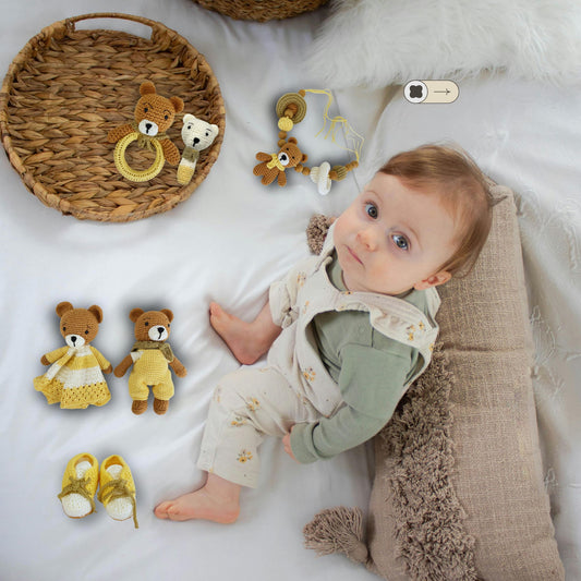 baby on bed looking up surrounded by handmade crib set with 6 pieces 