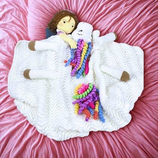 Handmade crochet unicorn toy/blanket with rainbow mane –a crochet doll holding   unicorn blanket while sleeping under it