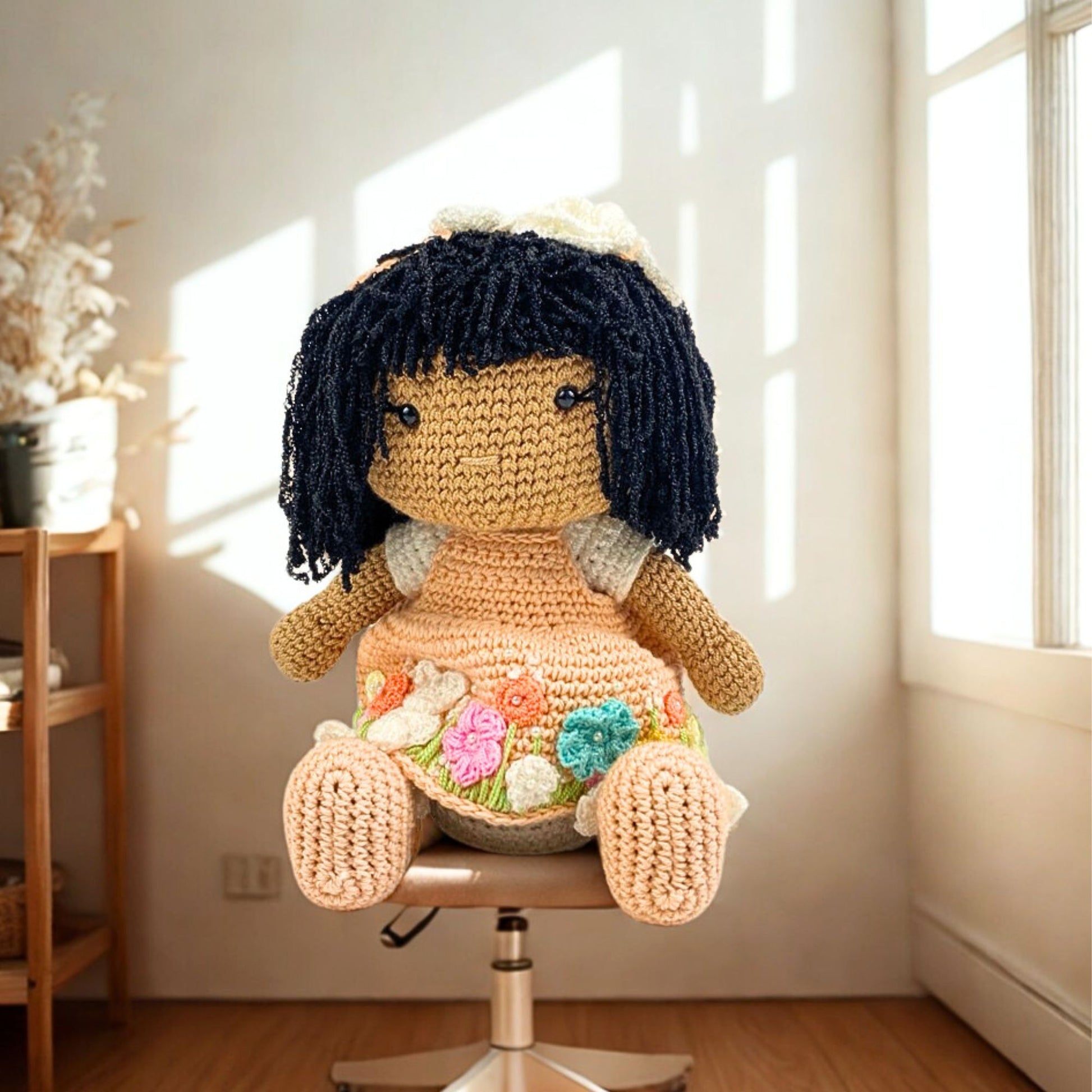 Handmade amigurumi 12 inch crochet doll with black yarn hair and floral peach dress, perfect for your kids