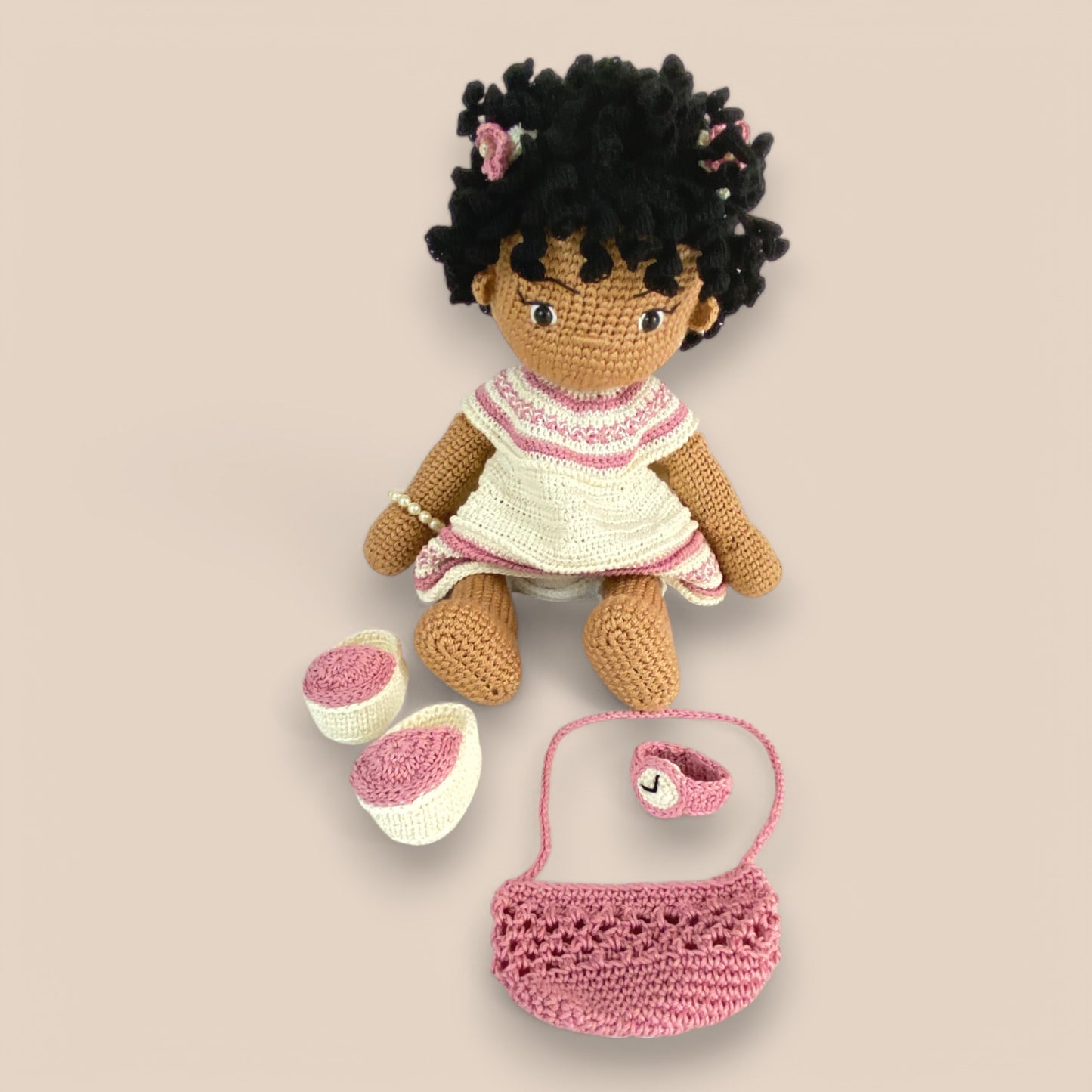 Ziggy doll seated with accessory set beside
