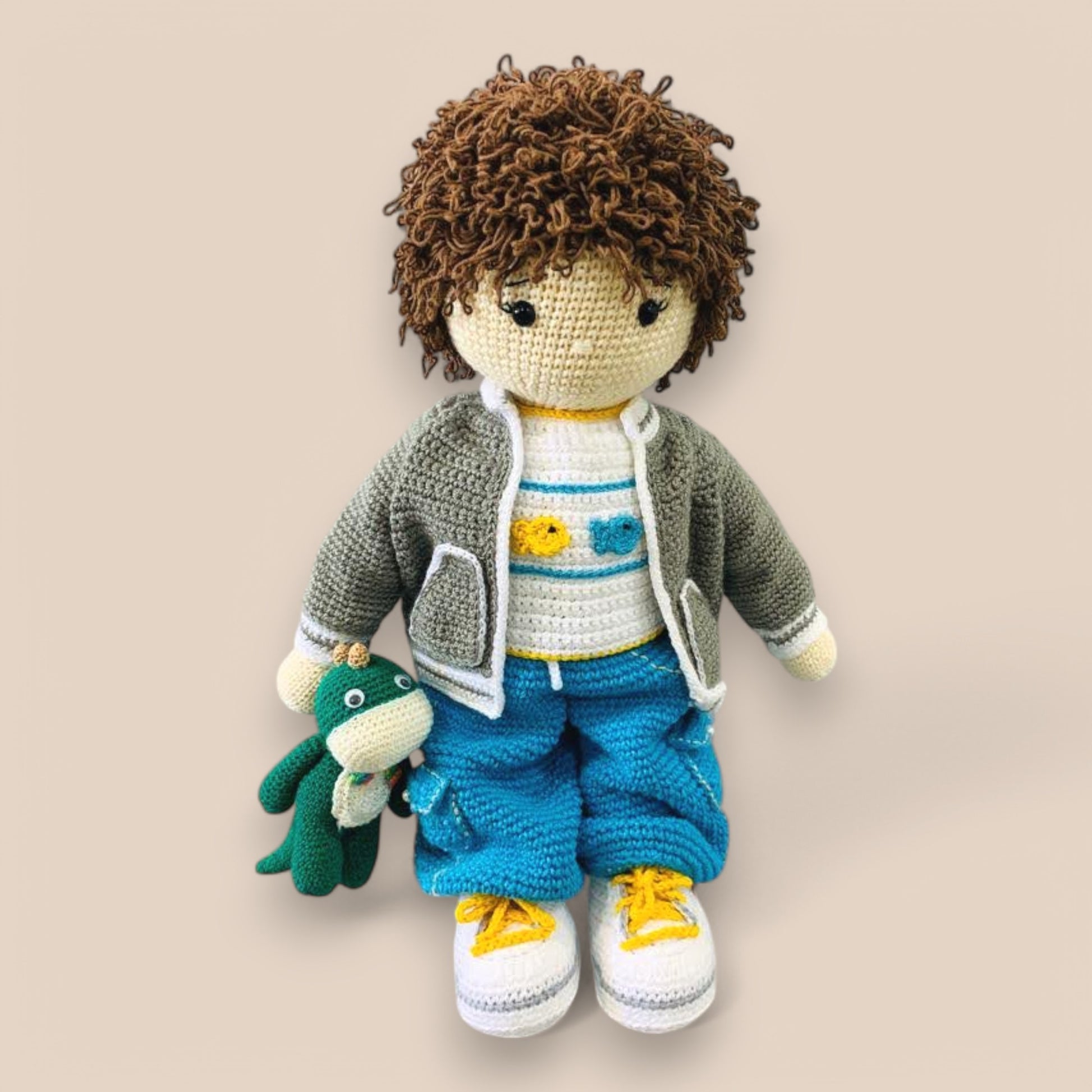 kyle crochet  amigurumi doll with no hat and bag holding green amigurumi toy