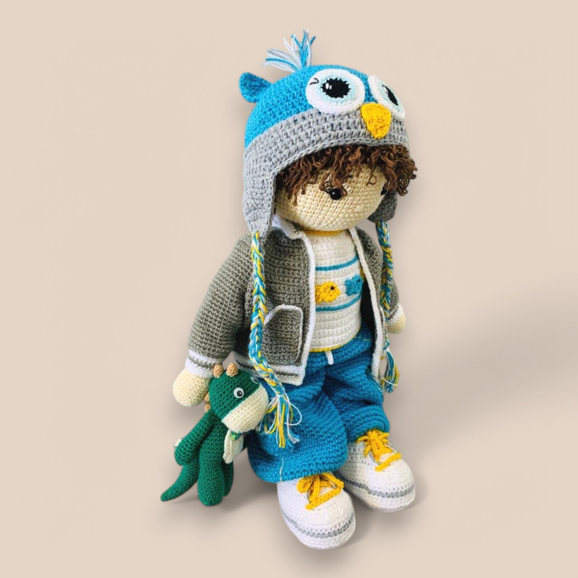 side view with kyle amigurumi crochet doll with small toy in hand