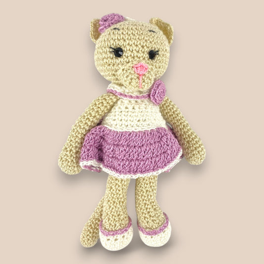 Mini handmade crochet bear doll dressed in white and purple , amigurumi soft toy for babies, perfect as a stroller charm, crib toy, or bag charm accessory – ideal baby shower or newborn gift

