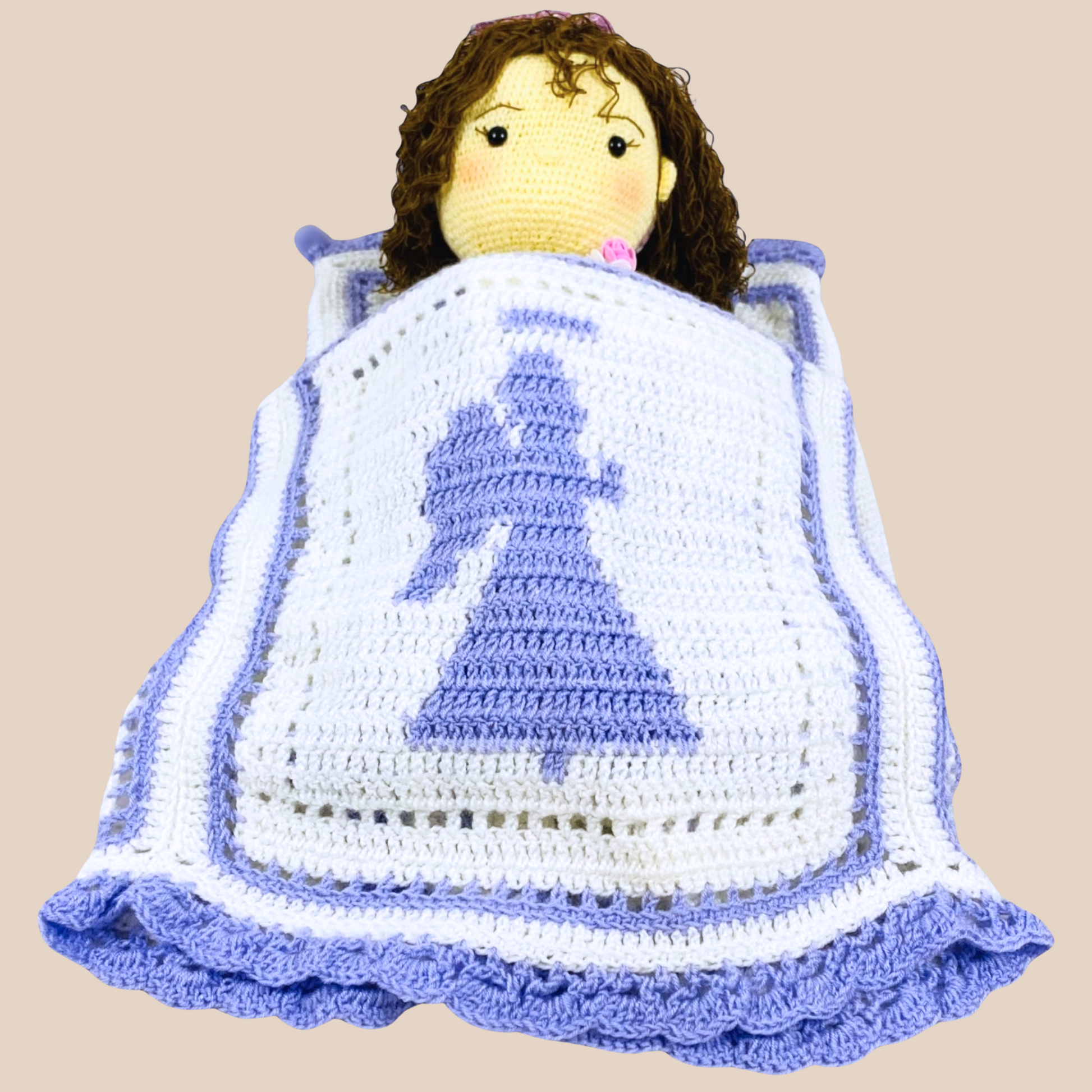 sleeping view of hand crochet blanket with corchet baby in it.